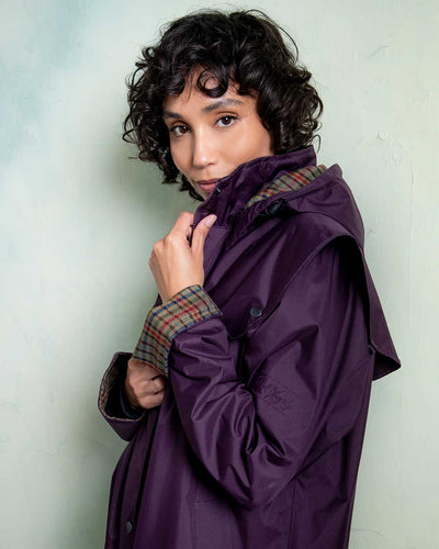 Black Berry coloured Jack Murphy Malvern Ladies Waterproof Bush Coat on wall background #colour_black-berry