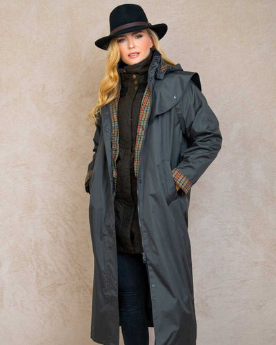 Olive coloured Jack Murphy Malvern Ladies Waterproof Bush Coat on wall background #colour_olive