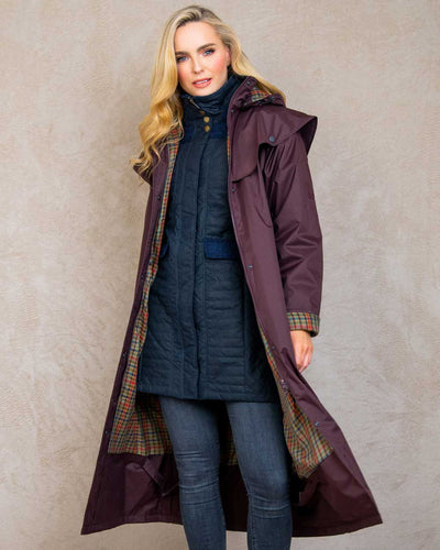 Deep Claret coloured Jack Murphy Malvern Ladies Waterproof Bush Coat on wall background #colour_deep-claret