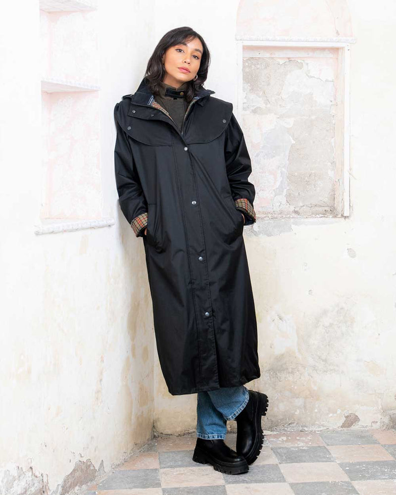 Black coloured Jack Murphy Malvern Ladies Waterproof Bush Coat on wall background 