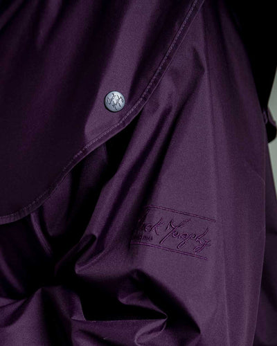 Black Berry coloured Jack Murphy Malvern Ladies Waterproof Bush Coat on wall background #colour_black-berry