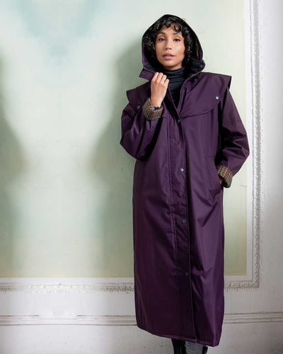 Black Berry coloured Jack Murphy Malvern Ladies Waterproof Bush Coat on wall background #colour_black-berry