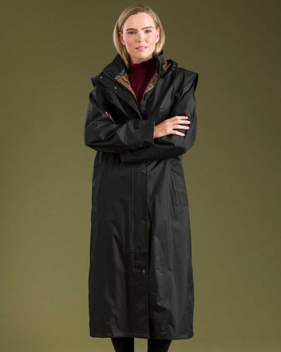 Black coloured Jack Murphy Malvern Ladies Waterproof Bush Coat on wall background #colour_black