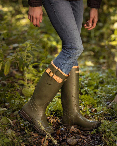 Olive Green coloured Ariat Womens Burford Wellington Boots on forest background #colour_olive-green