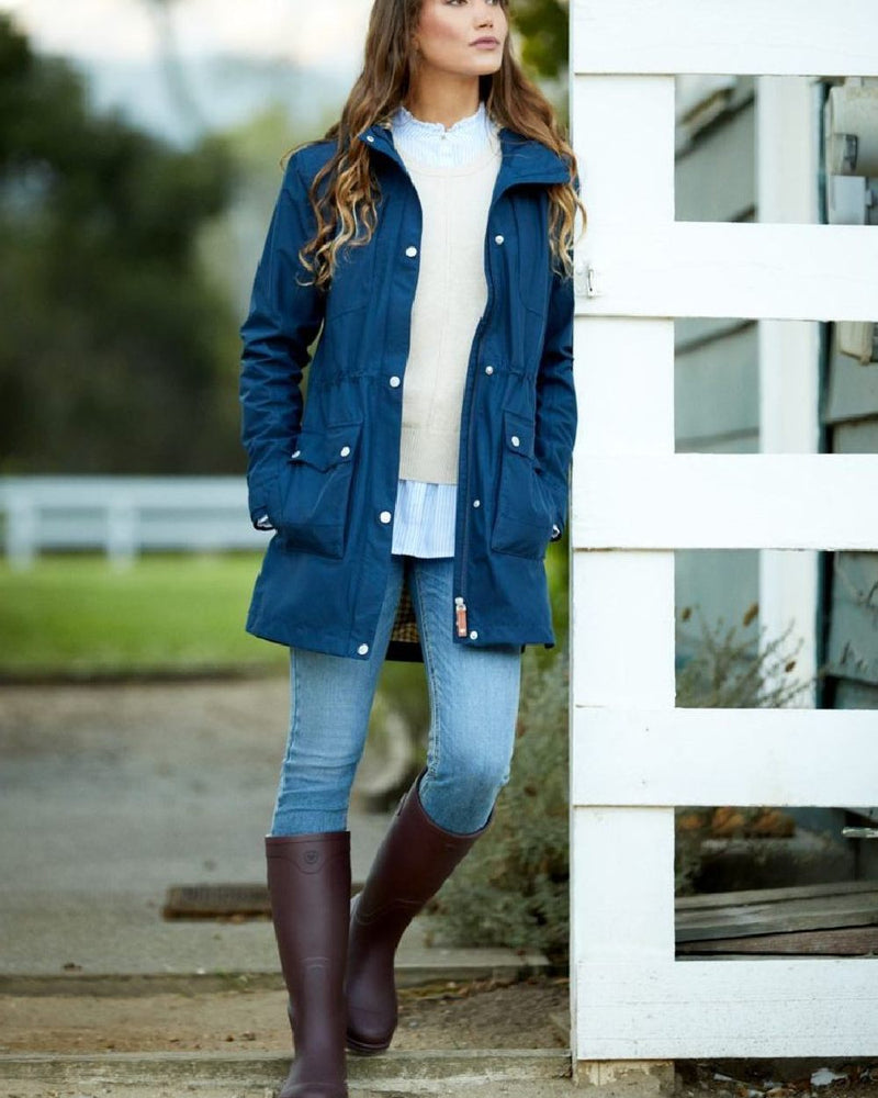 Maroon coloured Ariat Womens Kelmarsh Wellington Boots on country house background 