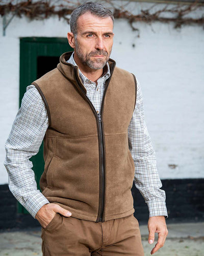 Camel Coloured Baleno Harvey Fleece Gilet on house background #colour_camel