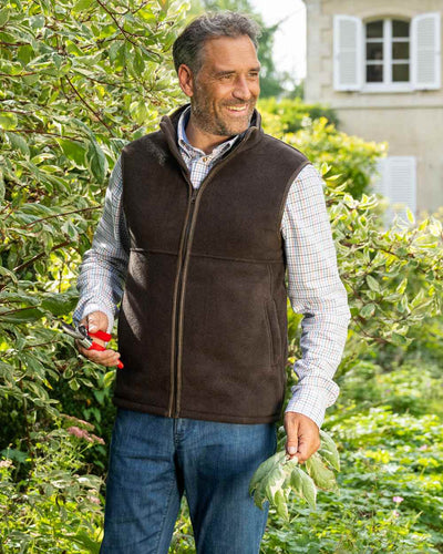 Chocolate Coloured Baleno Harvey Fleece Gilet on garden background #colour_chocolate