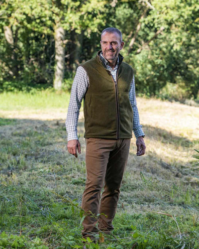 Olive Coloured Baleno Harvey Fleece Gilet on forest background #colour_olive