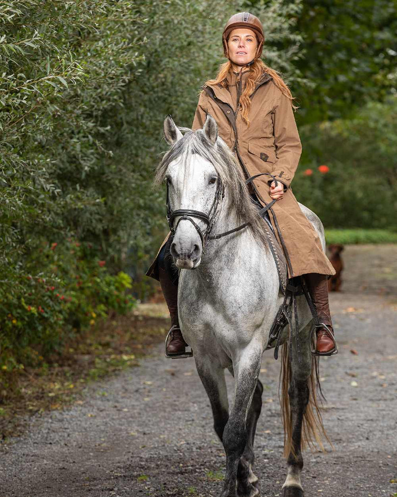 Camel Coloured Baleno Kensington Long Waterproof Coat On A Countryside Background 