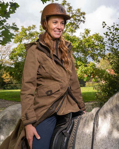 Camel Coloured Baleno Kensington Long Waterproof Coat On A Countryside Background #colour_camel