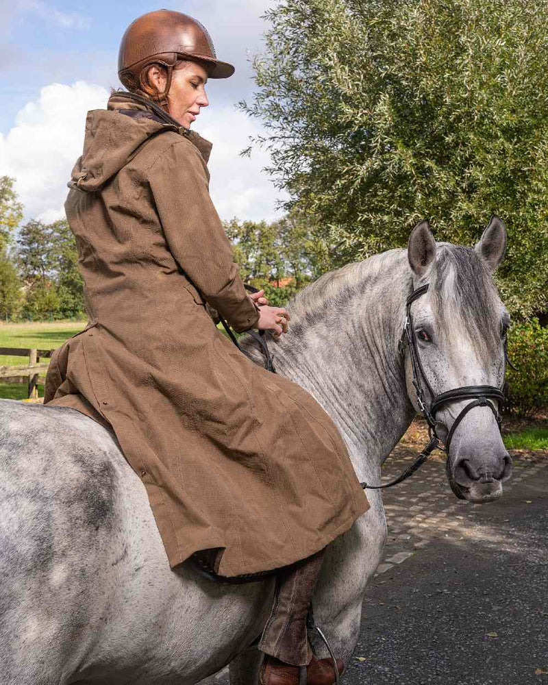 Camel Coloured Baleno Kensington Long Waterproof Coat On A Countryside Background 