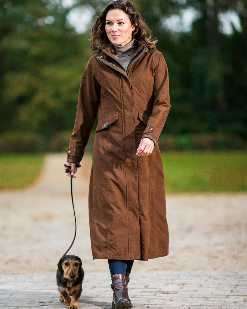 Earth Brown Coloured Baleno Kensington Long Waterproof Coat on blurry background 