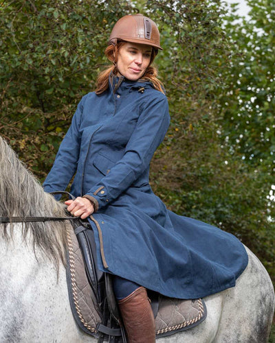 Navy Blue Coloured Baleno Kensington Long Waterproof Coat On A Countryside Background #colour_navy-blue