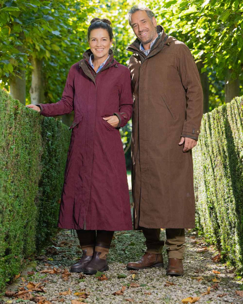 Raspberry Coloured Baleno Kensington Long Waterproof Coat On A Countryside Background 