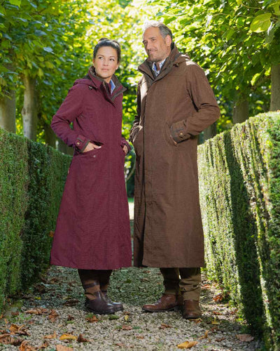 Raspberry Coloured Baleno Kensington Long Waterproof Coat On A Countryside Background #colour_raspberry