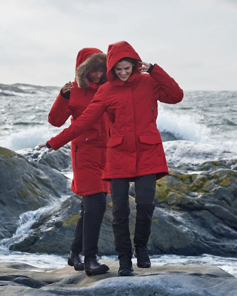 Pomme Red Coloured Didriksons Frida Womens Parka 7 On A Coastal Background 