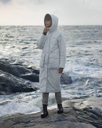 White Foam Coloured Didriksons Leya Womens Parka Long 3 On A Coastal Background #colour_white-foam