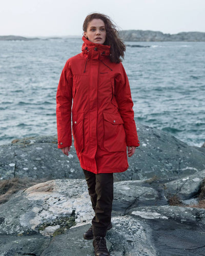 Pomme Red Coloured Didriksons Thelma Womens Parka 10 On A Coastal Background #colour_pomme-red