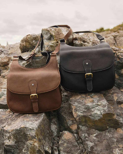 Walnut coloured Dubarry Balrickard Saddle Bag on rock background #colour_walnut