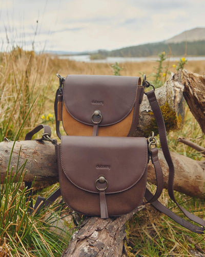 Camel coloured Dubarry Crossgar Saddle Bag on grassy background #colour_camel