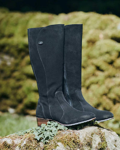 Black Suede coloured Dubarry Downpatrick Knee High Boots on rock background #colour_black-suede