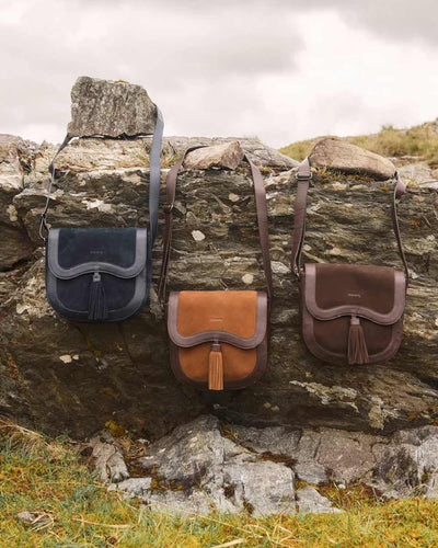 Camel coloured Dubarry Monart Saddle Bag on rock background #colour_camel