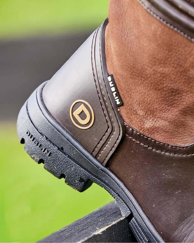 Brown coloured Dublin Husk Boots II on blurry background #colour_brown