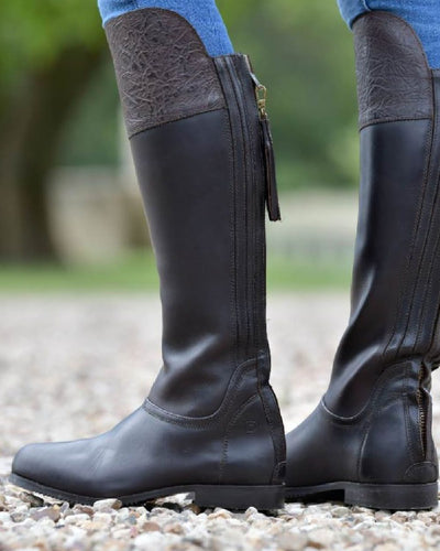 Dark Brown coloured Dublin Women's Nore Waterproof Boots on stone background #colour_dark-brown