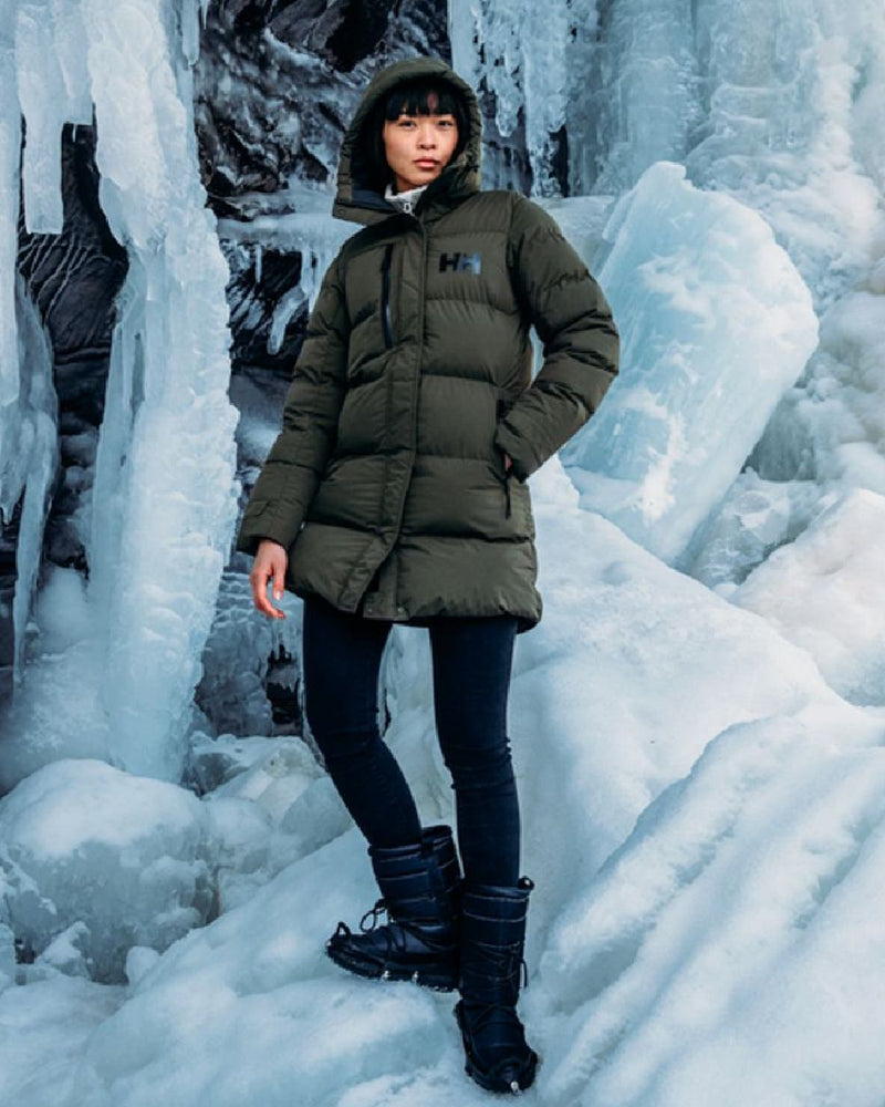 Utility Green Helly Hansen Adore Ladies Puffy Parka on ice background 