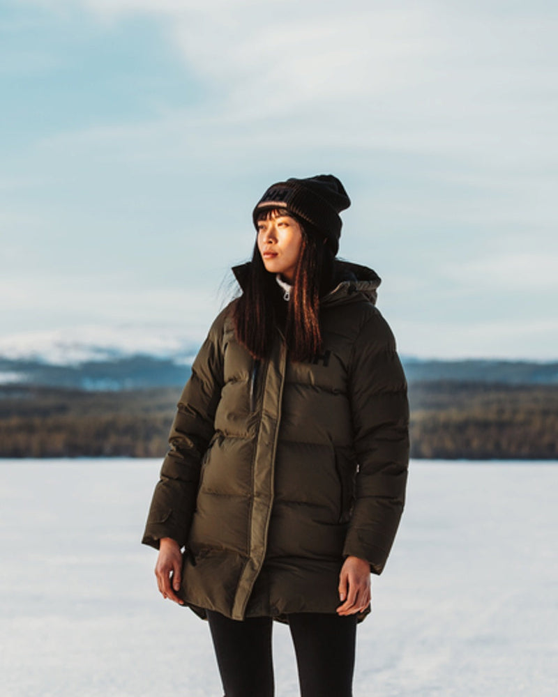 Helly Hansen Adore Ladies Puffy Parka on snow background 