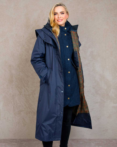 Heritage Navy coloured Jack Murphy Malvern Ladies Waterproof Bush Coat on wall background #colour_heritage-navy