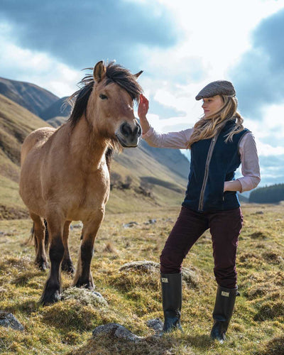 Midnight Navy Coloured Hoggs of Fife Stenton Ladies Fleece Gilet on mountain background #colour_midnight-navy