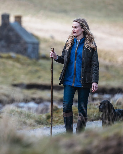 Nordic Blue Coloured Hoggs of Fife Stenton Ladies Fleece Gilet on blurry background #colour_nordic-blue