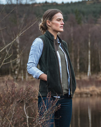 Pine Green Coloured Hoggs of Fife Stenton Ladies Fleece Gilet on lake background #colour_pine-green