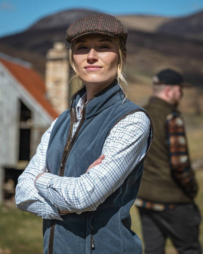 Slate Grey Coloured Hoggs of Fife Stenton Ladies Fleece Gilet on blurry background #colour_slate-grey