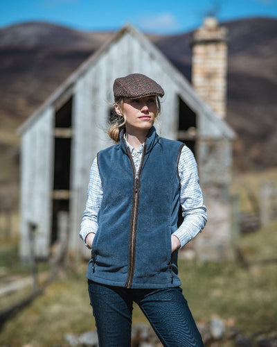 Slate Grey Coloured Hoggs of Fife Stenton Ladies Fleece Gilet on house background #colour_slate-grey