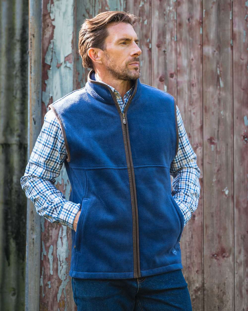 Nordic Blue coloured Hoggs of Fife Stenton Technical Fleece Gilet on forest background 