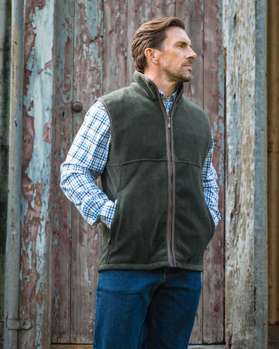 Pine Green coloured Hoggs of Fife Stenton Technical Fleece Gilet on forest background #colour_pine-green