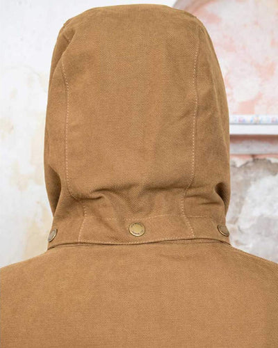 Camel coloured Jack Murphy Erin Long Waterproof Coat on wall background #colour_camel