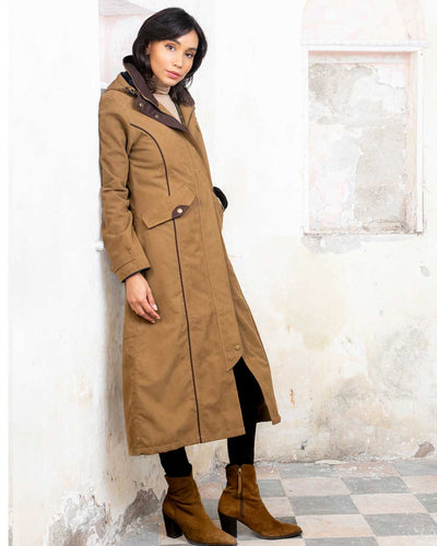 Camel coloured Jack Murphy Erin Long Waterproof Coat on wall background #colour_camel