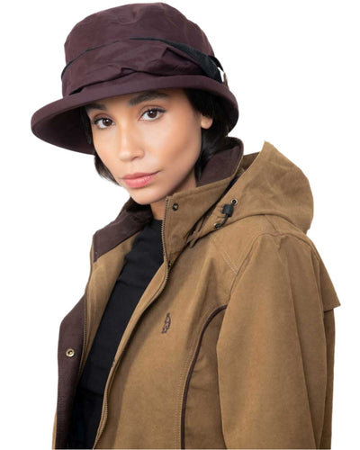 Camel coloured Jack Murphy Erin Long Waterproof Coat on wall background #colour_camel