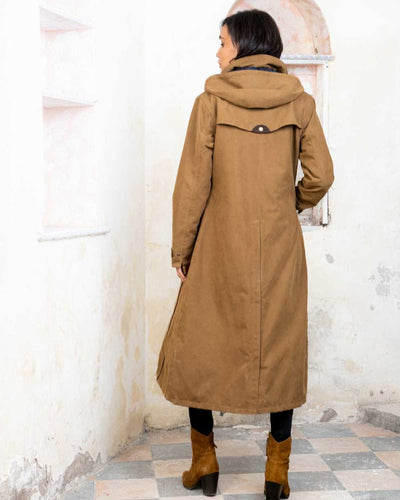 Camel coloured Jack Murphy Erin Long Waterproof Coat on wall background #colour_camel