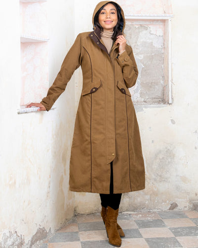 Camel coloured Jack Murphy Erin Long Waterproof Coat on wall background #colour_camel