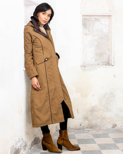 Camel coloured Jack Murphy Erin Long Waterproof Coat on wall background #colour_camel