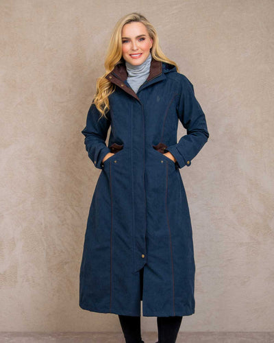 Heritage Navy coloured Jack Murphy Erin Long Waterproof Coat on wall background #colour_heritage-navy