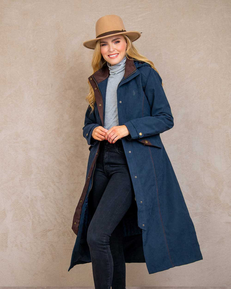 Heritage Navy coloured Jack Murphy Erin Long Waterproof Coat on wall background 