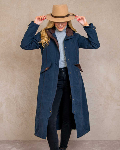 Heritage Navy coloured Jack Murphy Erin Long Waterproof Coat on wall background #colour_heritage-navy
