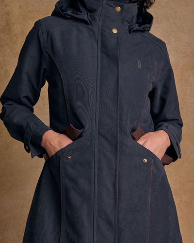 Heritage Navy coloured Jack Murphy Erin Long Waterproof Coat on wall background #colour_heritage-navy