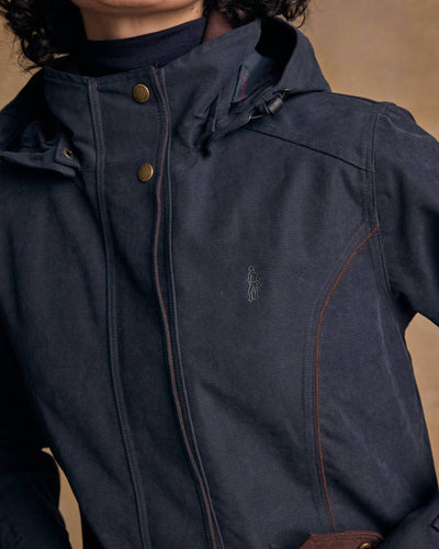 Heritage Navy coloured Jack Murphy Erin Long Waterproof Coat on wall background #colour_heritage-navy