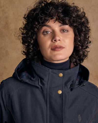 Heritage Navy coloured Jack Murphy Erin Long Waterproof Coat on wall background #colour_heritage-navy